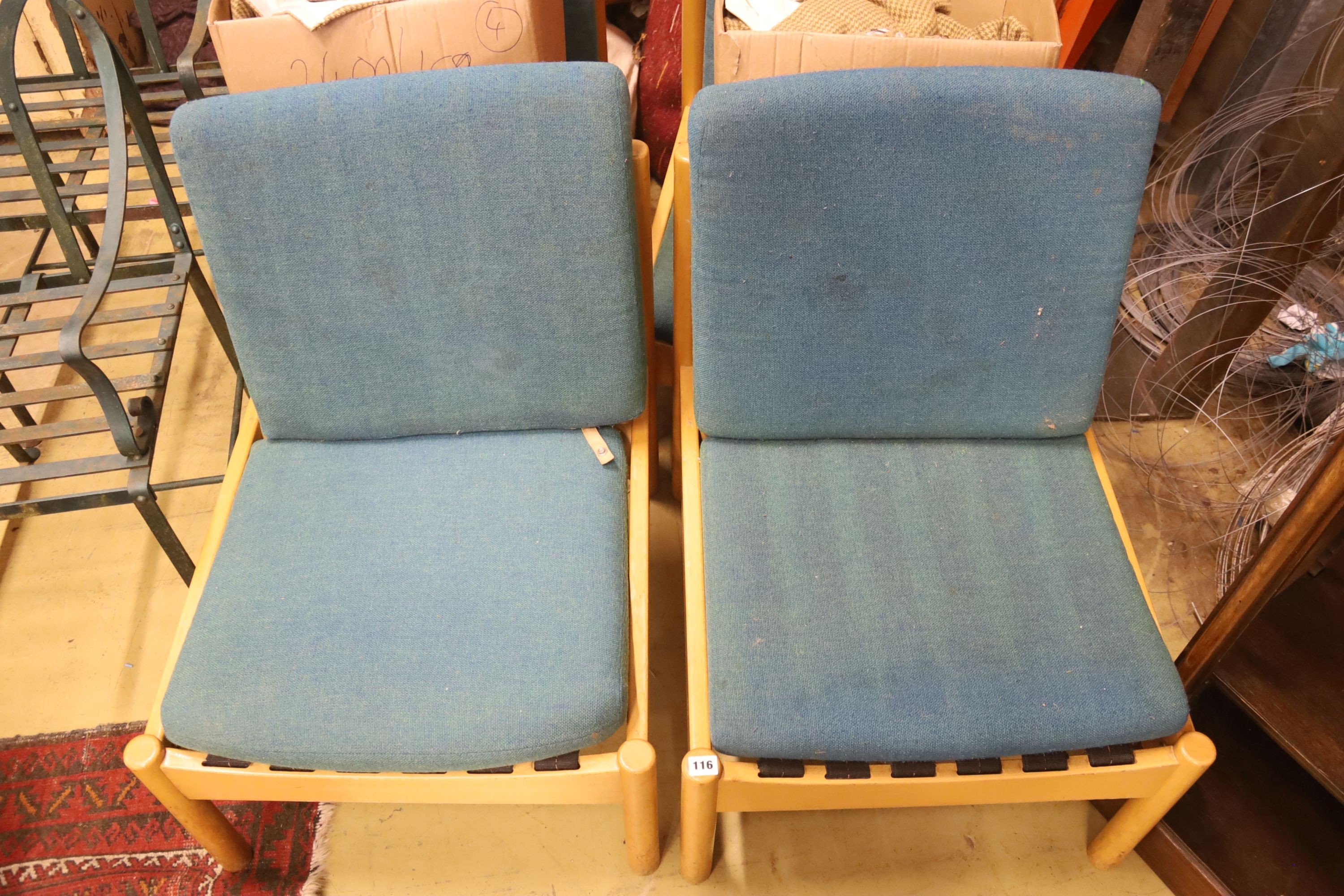 A set of four Ercol pale beech lounge chairs with cushion seats and backs, width 60cm, depth 66cm, height 82cm